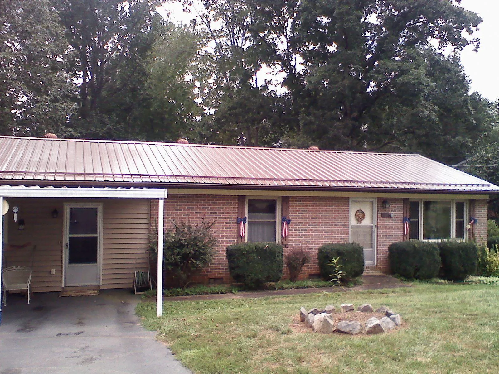 Bronze metal roof and carport on a brick ranch home — Roof Repair work by our crew in Good Hope